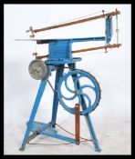 A vintage 20th century industrial Hobbies cast metal pedal foot powered fret saw raised on tripod