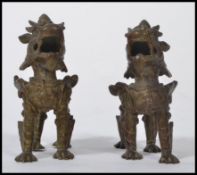 A pair of vintage 20th century bronze Asiatic possibly Chinese / Nepalese temple dogs