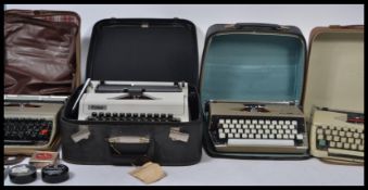 A collection of four  vintage retro cased portable typewriters dating from the mid 20th century.