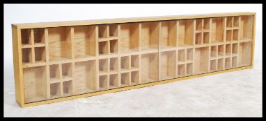 A solid wood hand made bespoke large pine rectangular shop cabinet having multiple sectional