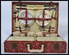 A vintage retro mid 20th century red cased Brexton picnic hamper set with contents. The case with