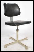 A vintage 20th century retro industrial office swivel chair raised on a quadruped base with black