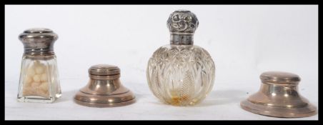 A collection of silver hallmarked items to include a silver topped cut glass perfume bottle, two