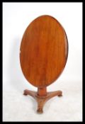 A 19th century Victorian mahogany tilt top table raised on a tripod base with finial legs.