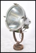 A large vintage 20th century retro industrial search lamps lights on cast metal bases with