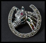A sterling silver plique a jour brooch in the form of a horse and horseshoe. Weighs 6 grams.