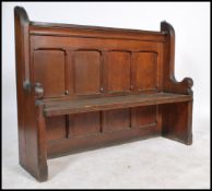 A 19th century solid oak eclesiastical church pew of shaped form being of small proportions. The