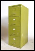 A vintage mid century metal filing cabinet having upright body with 4 drawers in original green