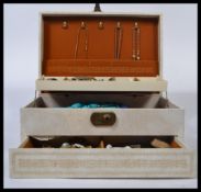 A collection of costume jewellery in dressing table jewellery box to include bracelets, bangles,
