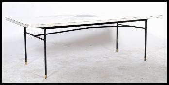 A vintage mid 20th century Long John coffee table having white formica top with graphic detail being