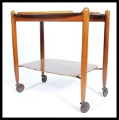 A 1970's retro teak wood Danish influenced butlers serving trolley raised on original castors, the