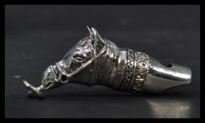 A sterling silver whistle in the form of a horses head. Weighs 14 grams.