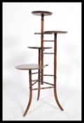 An early 20th century aesthetic movement four tier shop display millinery stand. Measures: 100cm