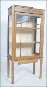 An Edwardian oak display cabinet having a lined in