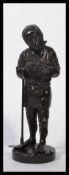 A Meiji period late 19th century Oriental Japanese bronze statue figurine of a farm worker raised on
