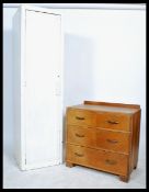 A 1920's oak chest of drawers raised on an inset plinth base with a series of drawers together