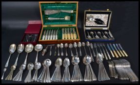 A large collection of silver plated wears along with a group of silver hallmarked flatware.