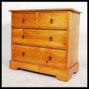 A Victorian Arts & Crafts pine cottage chest of drawers having 2 short over 2 deep drawer