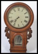 A 19th century Victorian wall mounted drop dial school clock having a mahogany case with carved side