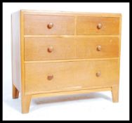 A mid 20th century Air Ministry golden oak chest of drawers having short and deep drawer