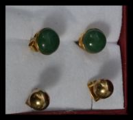 Two pairs of 9ct gold earrings. One pair set with green stones, both having post backs. Tests 9ct