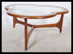 A retro 20th century teak wood framed coffee table of trefoil shape raised on united shaped supports