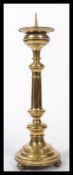 A large early 19th century Georgian ecclesiastical cast and spun brass large candlestick raised on