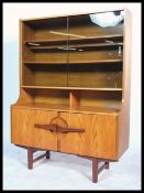 A 1970's retro teak wood sideboard - room divider cabinet having danish influence being raised on