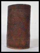 An early 20th century Chinese carved bamboo brush pot of cylindrical form with carved recessed