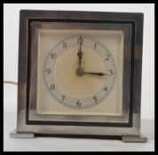 A 1930's Art Deco chrome and bakelite mantel clock by Temco. The decorative face with bakelite
