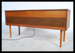 A retro 20th century teak cased radiogram by Alba lift up lid opening to reveal a three speed record
