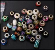 A collection of 925 silver and glass beads to incl