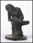 A French school figural bronze study of a Boy picking a thorn from his foot.  Patinated bronze and