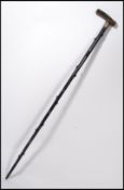 A silver hallmarked scroll work collared horn handled walking cane on blackthorn shaft