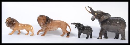 A group of four Beswick ceramic figurines to include two lions , an elephant and a large elephant (