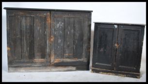 An early 20th century school cupboard of pine construction having ebonised finish together with