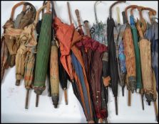 A very large collection of vintage early 20th century Edwardian umbrellas / parasols to include palm