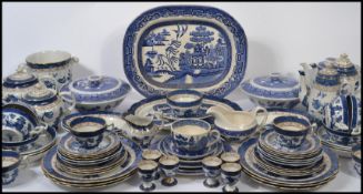 A good collection of vintage blue and white Staffordshire ceramics in the Willow pattern, dating