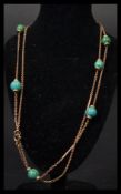 A mid 20th century 9ct gold and turquoise necklace having bar and chain links with polished