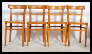 A retro mid century tubular metal and yellow formica kitchenette dining table together with a set of