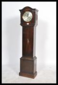 A vintage 20th century oak cased granddaughter clock having an inset eight day movement