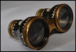A pair of 19th / early 20th century opera glasses having black enamel decoration with cartouche