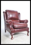 A 20th century G-Plan oxblood leather Chesterfield armchair bearing original label having barrel
