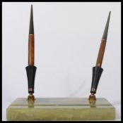 A 20th century Art Deco desk tidy / pen holder having two pens within stands, each pen with inset