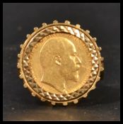 An early 20th century half sovereign ring having a 1909 gold half sovereign set to an oversized