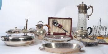 A collection of silver plate items to include a cut glass claret jug, silver plated twin handled