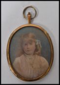 A 19th century miniature watercolour painting of a young girl, signed to the verso Moffat. Set