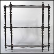 A 19th century Coromandel wood etagere whatnot of shaped form with multiple shelves having barley