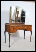 A vintage 20th century Queen Anne revival walnut dressing table having an arrangement of drawers