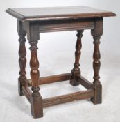 An 18th / 19th century country oak peg jointed stool being raised on gun barrel turned supports